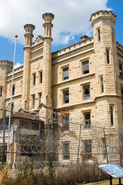 A large building with a barbed fence