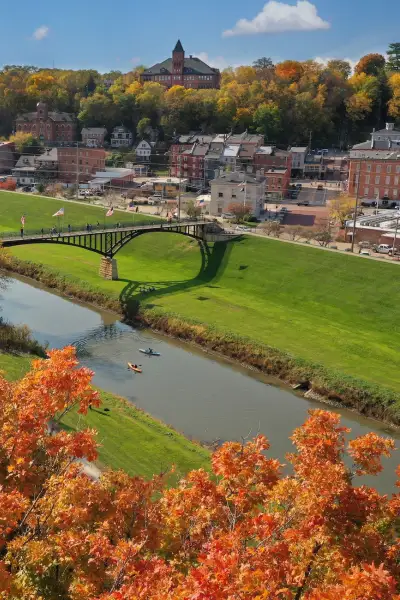 A fall day in Galena, orange foliage and people kayak in a river