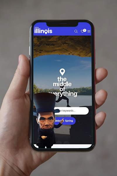 A phone showing the EnjoyIllinois.com website with BIG Lincoln